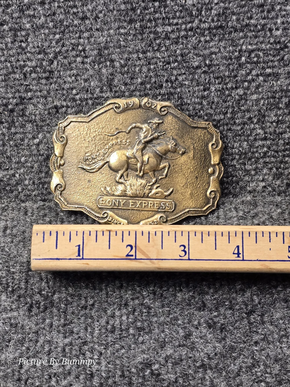 Vintage brass-tone Pony Express belt buckle featuring a cowboy on horseback